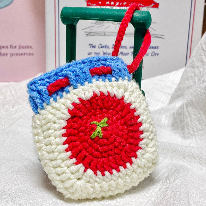 Crocheted red tomato Bluetooth earphone bag